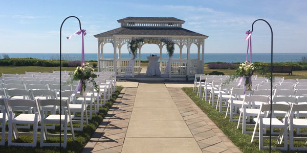 A gazebo at The Lodge at Geneva-on-the-Lake is decorated with flowers for a wedding ceremony 